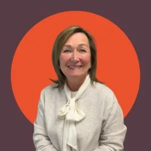 Smiling woman with orange circle background.