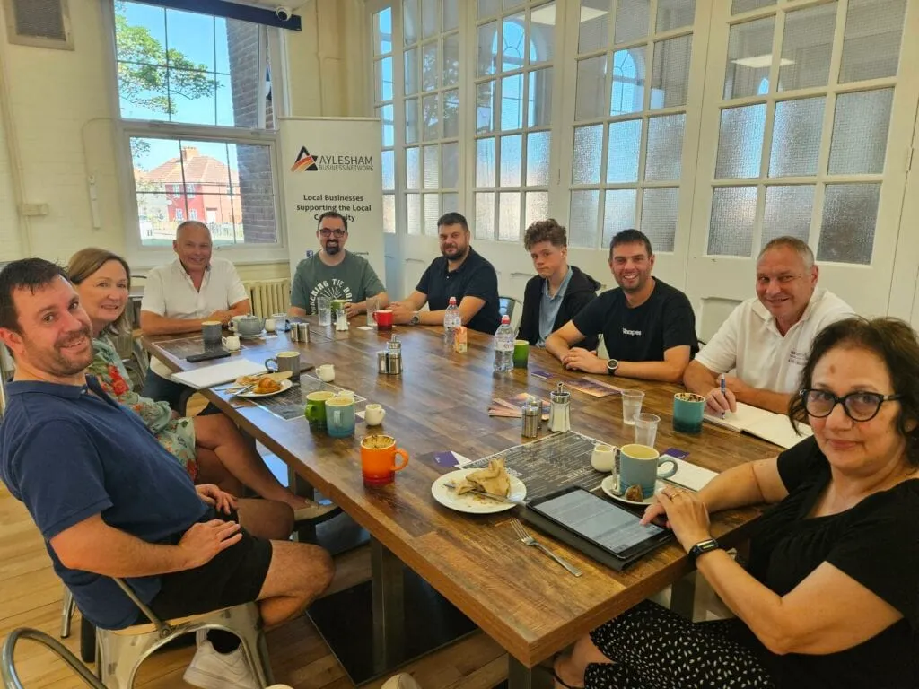 Business meeting with nine people around a table.
